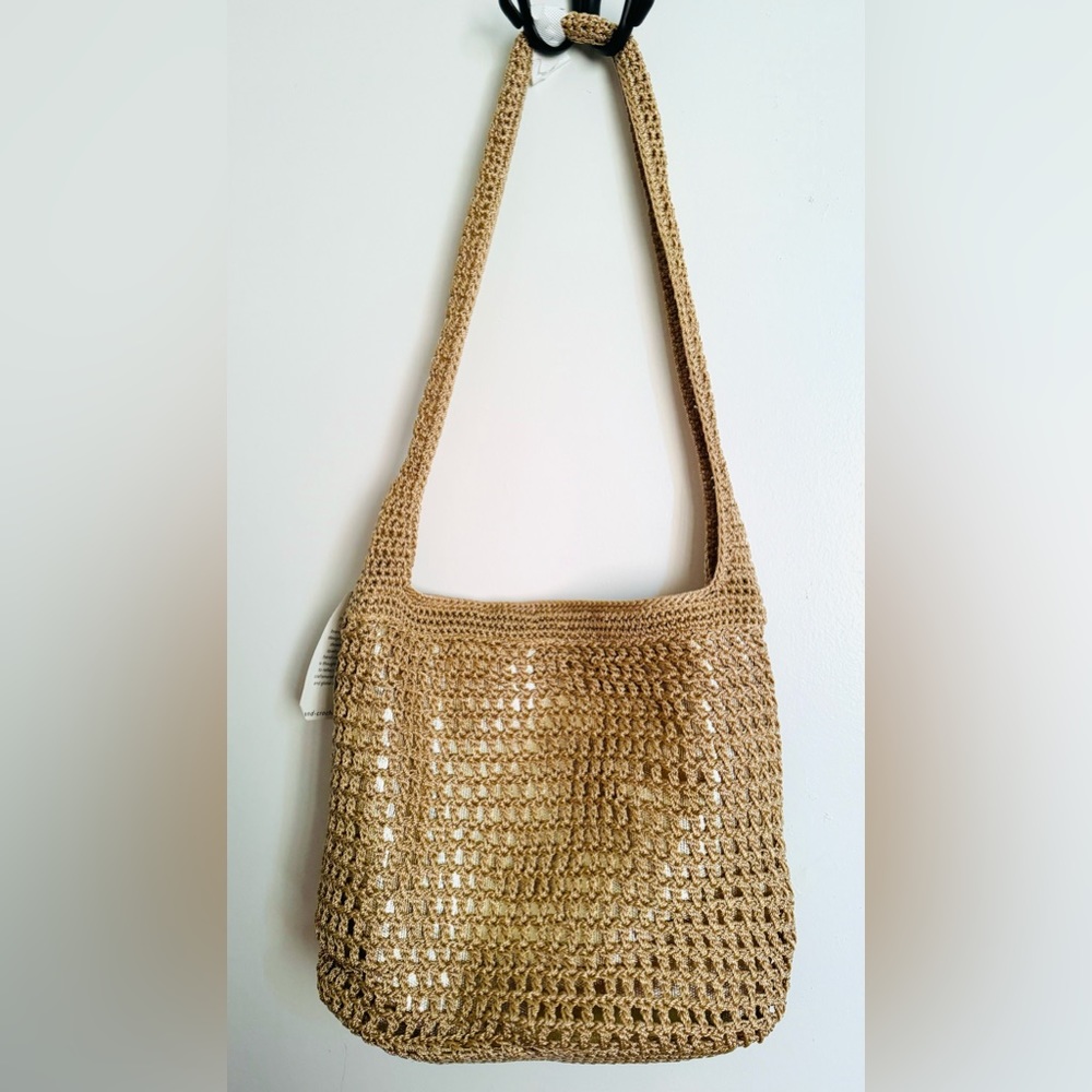 NWT. The Sak crochet handbag in Gold color.